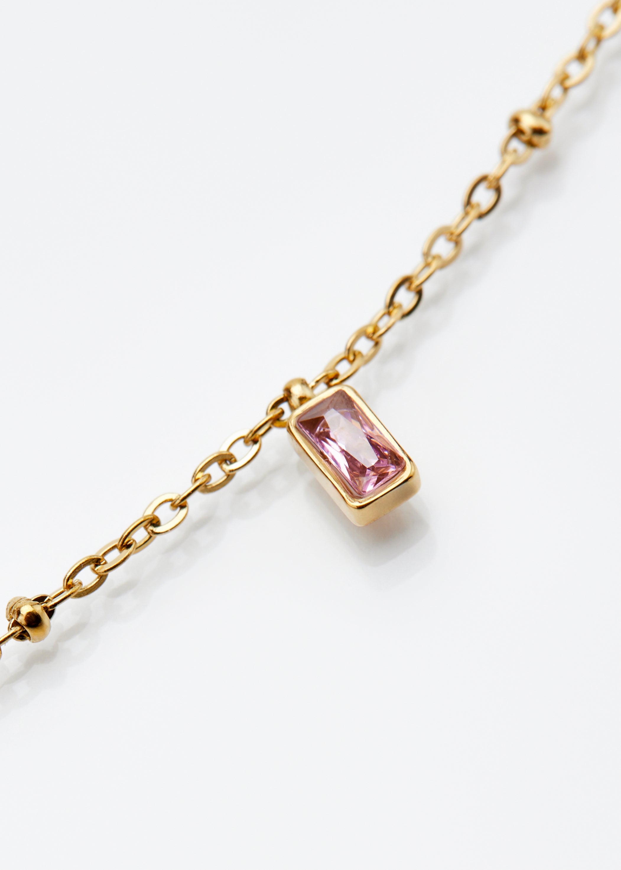 Gold chain with pink stone