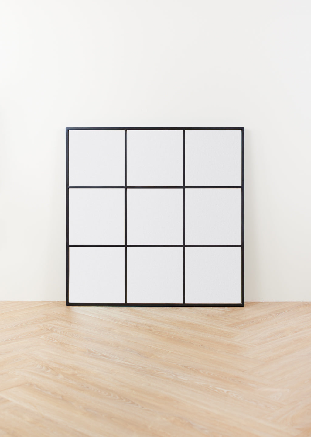 Small black wall mirror with grid